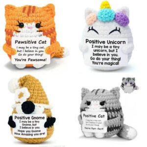 A handmade amigurumi doll with a simple embroidered face, wearing a cute outfit, sitting in a gentle pose.